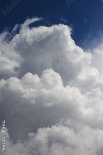 Natural background of fluffy white clouds on blue sky 