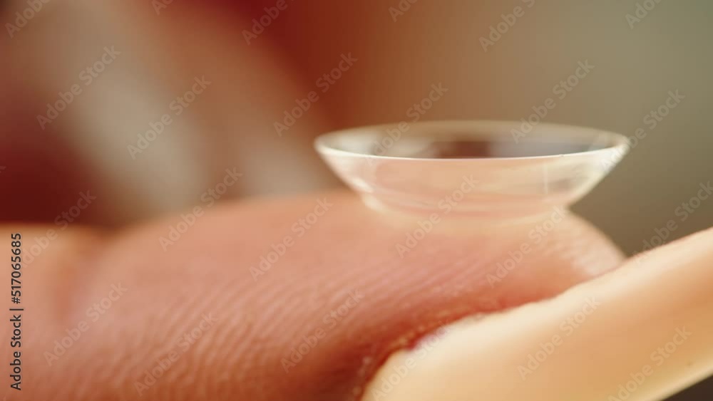 Eye lens on finger, decorative lenses. Optical shop concept. African American woman holding contact daily lenses for make-up and performances, halloween. Eye lens on finger, decorative lenses. Optical shop concept. African American woman holding contact daily lenses for make-up and performances, halloween.