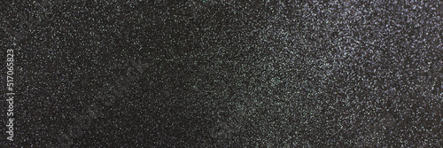 Black shiny background with sparkles. Dark gray abstract festive background. Web banner