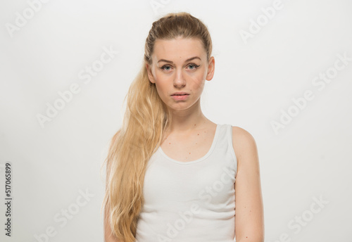 Portrait of a beautiful young women, dressed white T-shirt , isolated on white.emotional portrait of a young Ukrainian girl