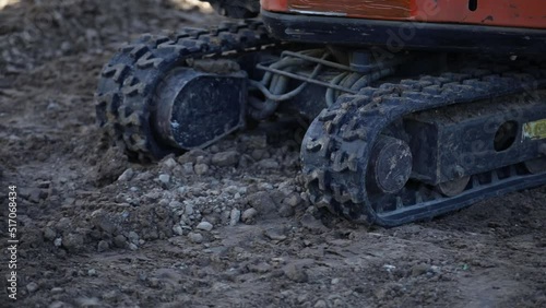 Crawler excavator moves on the surface of loose soil