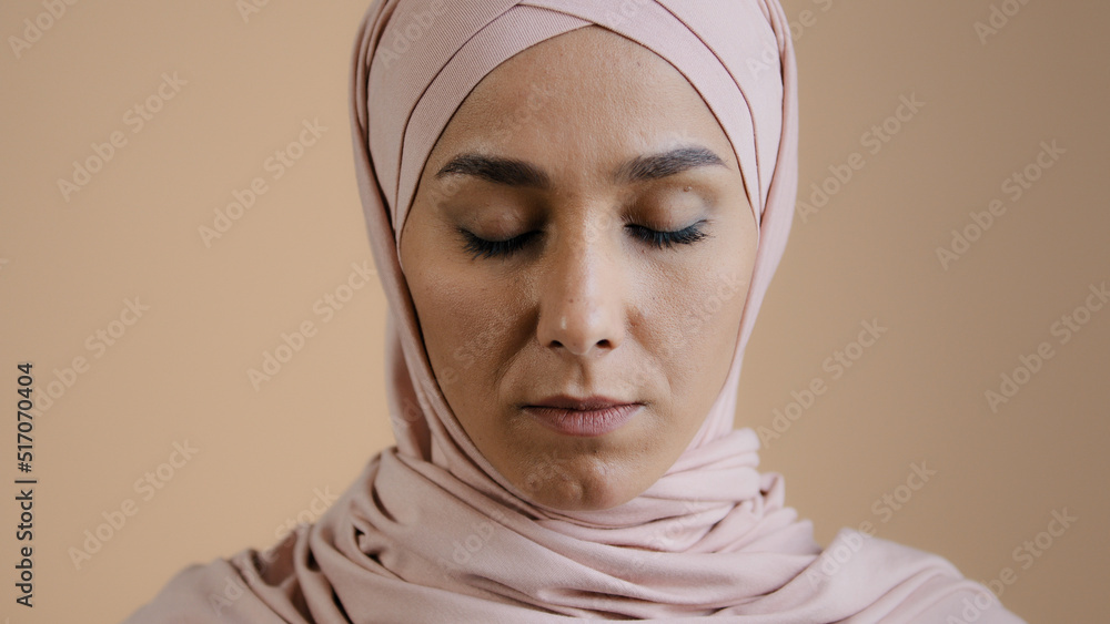 Portrait of pretty upset muslim girl woman in hijab headscarf islamic young anxious lonely lady in desperate with closed eyes indoors feeling worry about religious discrimination show problem sadness Portrait of pretty upset muslim girl woman in hijab headscarf islamic young anxious lonely lady in desperate with closed eyes indoors feeling worry about religious discrimination show problem sadness