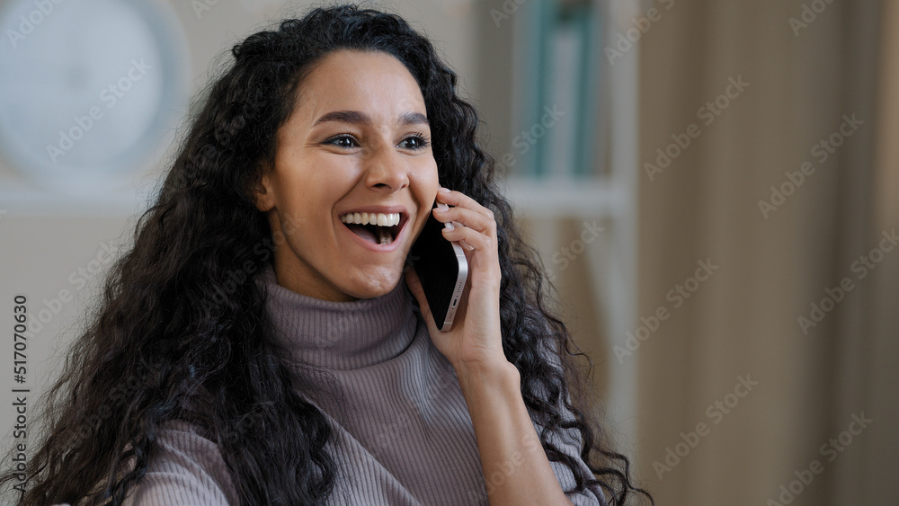Pretty arabian smiling girl young lady talk by mobile phone enjoy wireless conversation tell gossip shocked joyful happy millennial woman glad hear good news positive feedback happy for success deal Pretty arabian smiling girl young lady talk by mobile phone enjoy wireless conversation tell gossip shocked joyful happy millennial woman glad hear good news positive feedback happy for success deal