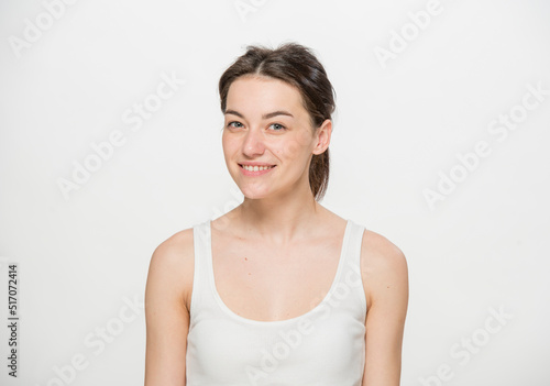 Close-up portrait of a beautiful young woman dressed in a white t-shirt isolated on white.'portrait of a young Ukrainian girl with different emotions