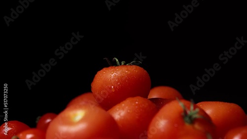 Bunch of washed fresh red tomatoes with little water drops. photo