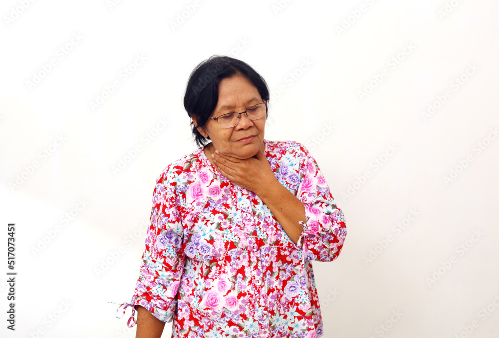 Sick senior adult elderly woman touching the neck feeling unwell coughing with sore throat pain Sick senior adult elderly woman touching the neck feeling unwell coughing with sore throat pain