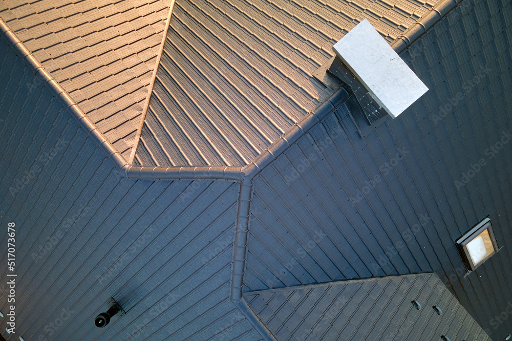 Closeup of house roof top covered with ceramic shingles. Tiled covering of building Closeup of house roof top covered with ceramic shingles. Tiled covering of building