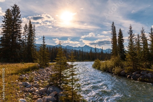 Bright Sunny Sky Glowing Over The Banff River