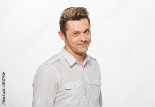 close-up portrait of a man in a white shirt on a white background isolated.portrait of a man with different emotions isolated. © serhii
