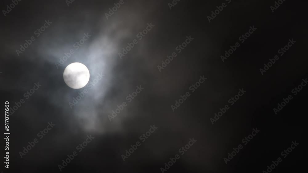 Night sky is illuminated by full moon shining through dark clouds which take over turning sky black. Night sky is illuminated by full moon shining through dark clouds which take over turning sky black.