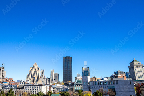 Skyline of the Old Montreal, or Vieux Montreal, Quebec, Canada with Notre Dame Basilica in front, & stone & glass Skyscrapers in the background showing the  touristic landmarks of the historical city © Jerome