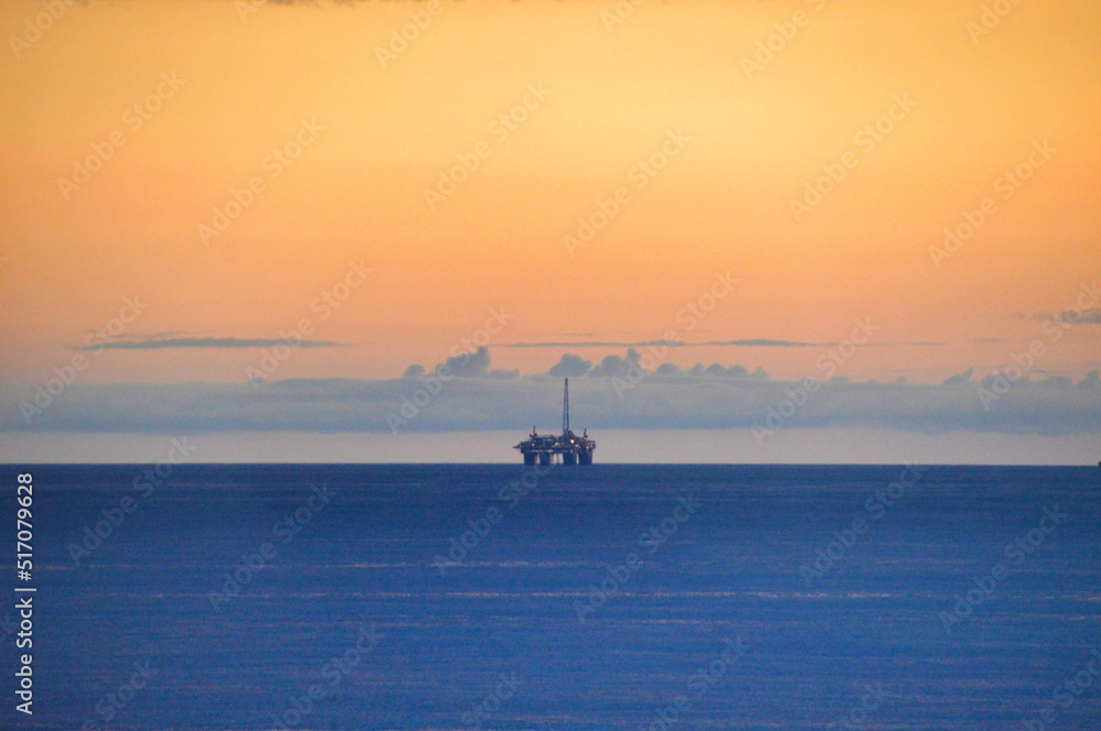 Offshore oil platform with its sunset over the Arctic Circle, Norway