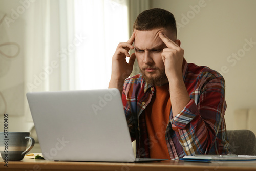 Online test. Man studying with laptop at home