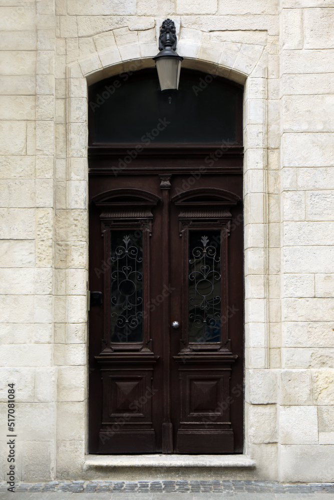 View of house with beautiful arched wooden door. Exterior design View of house with beautiful arched wooden door. Exterior design