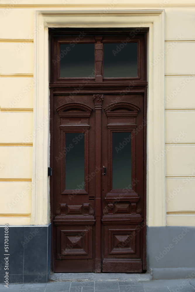 Entrance of house with beautiful wooden door and transom window Entrance of house with beautiful wooden door and transom window