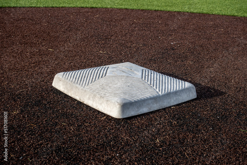 Photography close up view of a base on a clean baseball field on a bright, sunny day