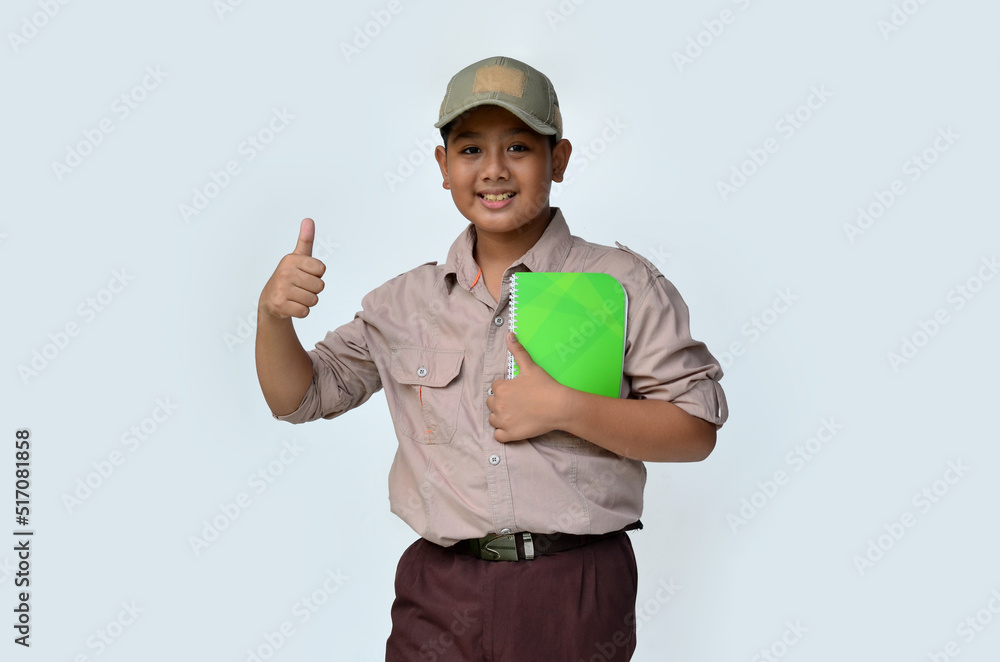 handsome asian boy with thumbs up expression wearing scouting outfit, isolated at white background handsome asian boy with thumbs up expression wearing scouting outfit, isolated at white background