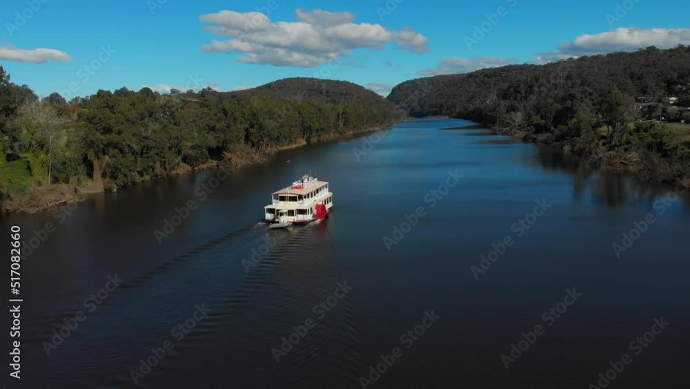 Drone video of the Nepean Belle Paddlewheeler moving along the nepean river on a clear blue sky day Drone video of the Nepean Belle Paddlewheeler moving along the nepean river on a clear blue sky day