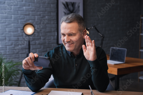 Happy mature man with mobil...