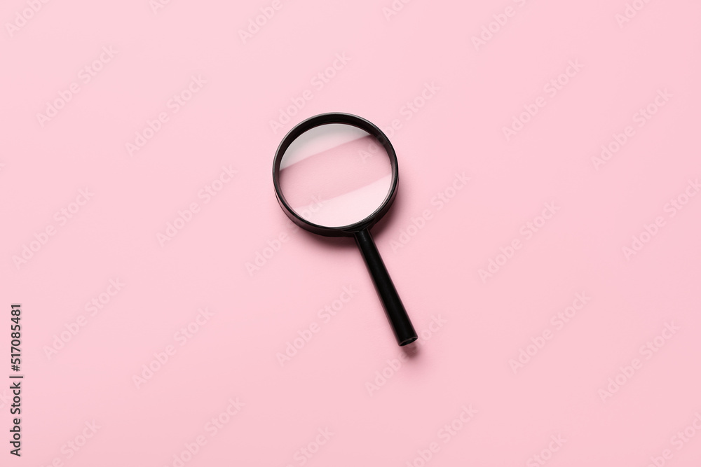 Magnifying glass on pink background Magnifying glass on pink background