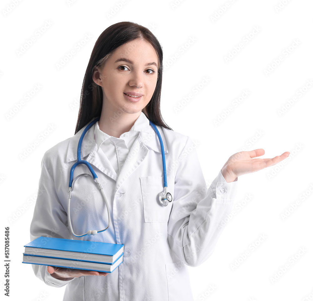 Female medical assistant with books showing something on white background Female medical assistant with books showing something on white background