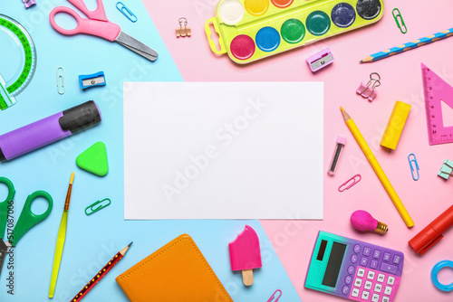 Blank paper sheet with school stationery on blue and pink background