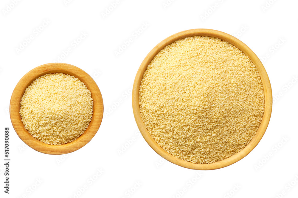 Raw couscous in a wooden bowl isolated on white background top view. Raw couscous in a wooden bowl isolated on white background top view.