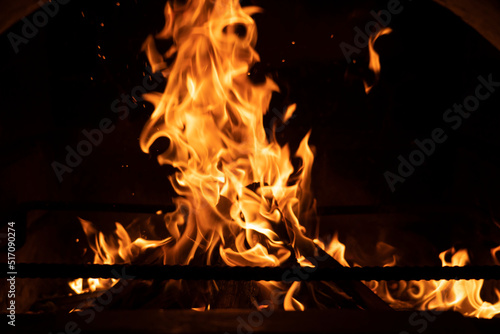 Fire flame in the fireplace. Tongues of flame on a black background. High quality photo