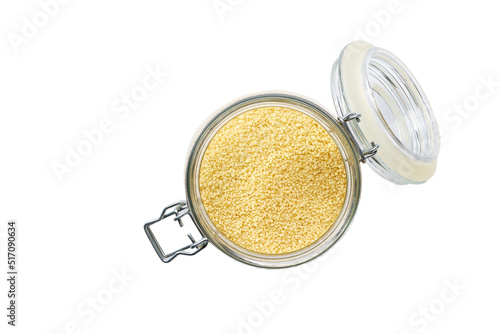 Heap of uncooked dry amaranth grains in glass storage jar isolated on white background top view.