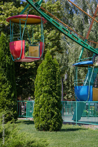 City amusement park. Ferris wheel with colored booths. Close-up. photo