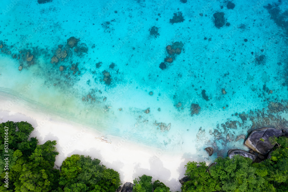 Sunny aerial view and aerial photographs of the beautiful tropical paradise beach of the Andaman Sea. amazing view Beach, turquoise water and coral amazing under the sea.
