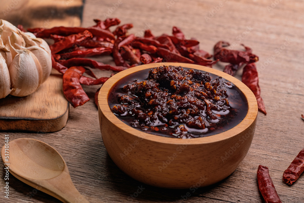 Thai spicy chili paste in a wooden cup (nampnikpao) Thai spicy chili paste in a wooden cup (nampnikpao)
