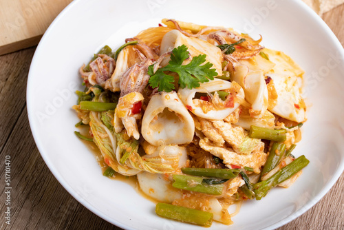 Sukiyaki dried squid Thai food in white bowl on wooden background