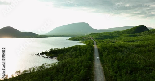 Aerial view following a rv driving towards the Saana fell, sunny, summer day, in Kilpisjarvi, Finland photo