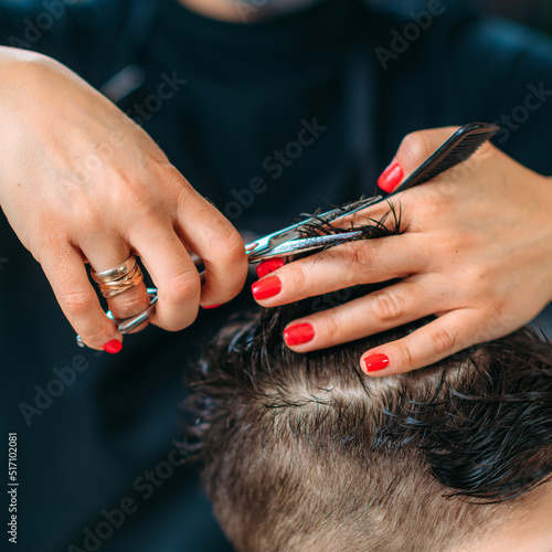 Close-Up of A Child Hairdresser's Hands with Scissors