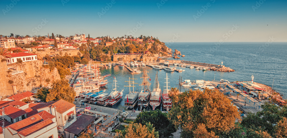 Aerial sunset view of the picturesque harbor with marina port with cruise tourist ships near the old town of Kaleici in Antalya. Turkish Riviera and resort paradise