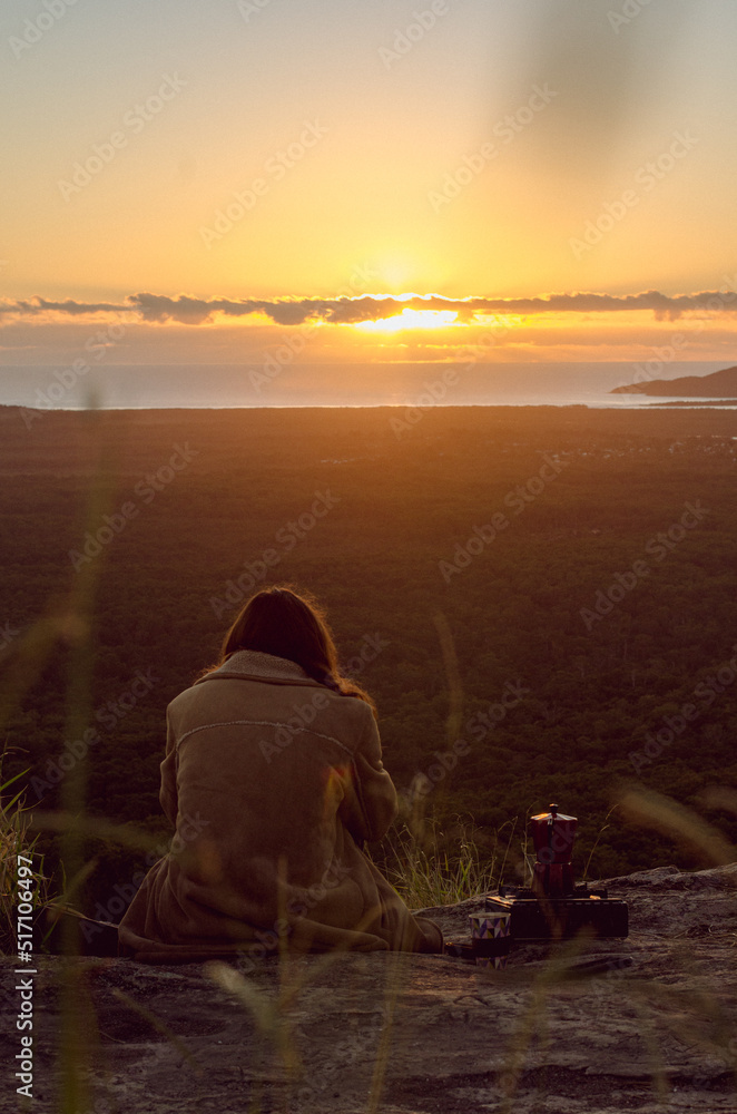 person on the mount watching at the beach at sunrise with coffee camping person on the mount watching at the beach at sunrise with coffee camping