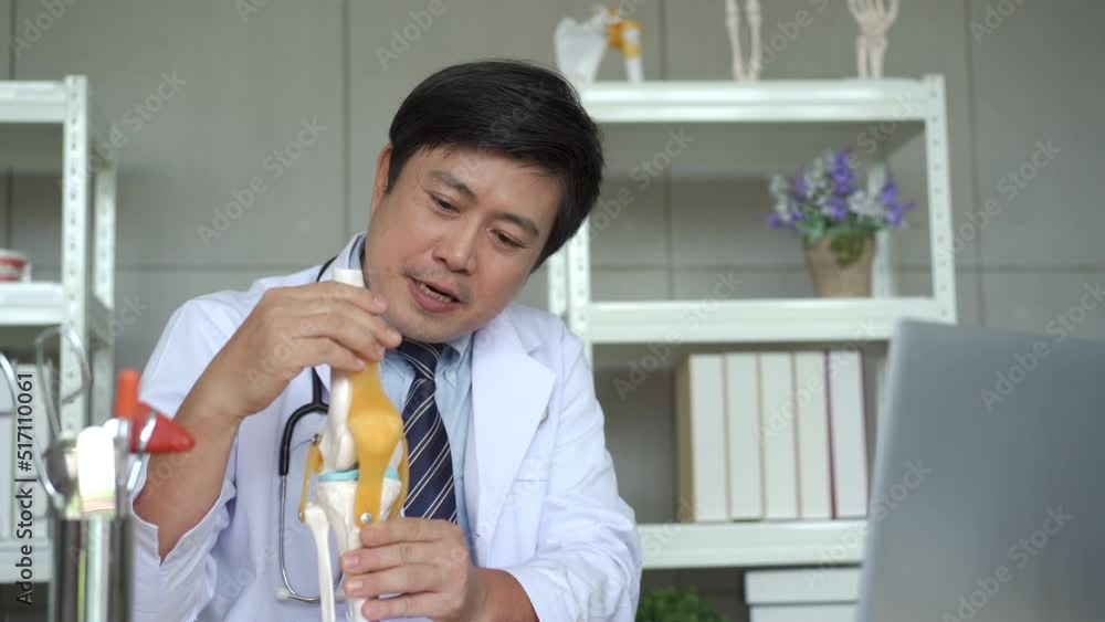 Asian male doctor explaining the examine result to patient on video conference.