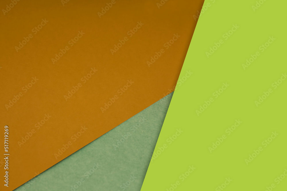 Plain and textured orange yellow green sheet paper arrangement background forming a triangle for creative cover designing