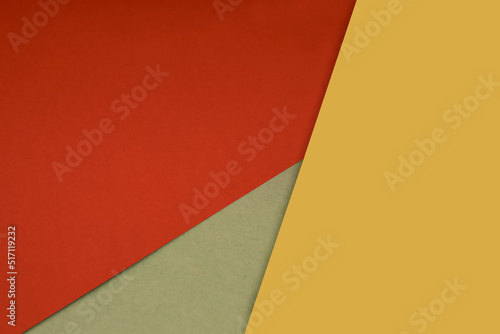 Dark and light, Plain and Textured Shades of red yellow green papers background lines intersecting to form a triangle shape