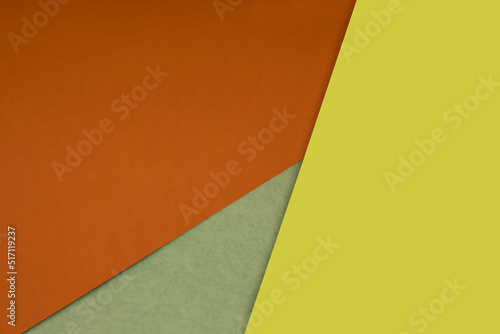 Dark and light, Plain and Textured Shades of orange yellow green papers background lines intersecting to form a triangle shape