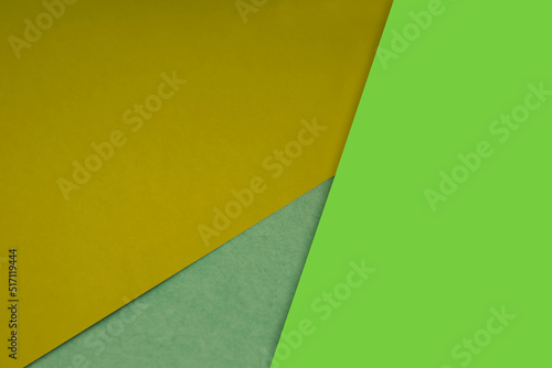 Dark and light, Plain and Textured Shades of yellow neon green papers background lines intersecting to form a triangle shape