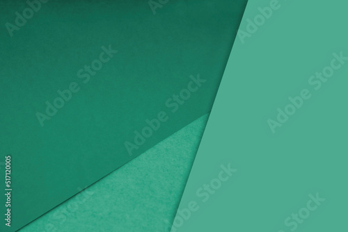 Dark and light, Plain and Textured Shades of green blue papers background lines intersecting to form a triangle shape