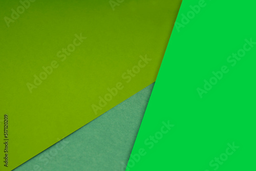 Dark and light, Plain and Textured Shades of yellow green papers background lines intersecting to form a triangle shape