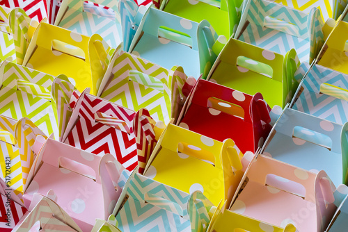 Small favors in the shape of colored cardboard boxes photo