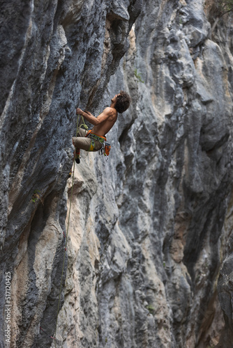rock climber climbs the rock.