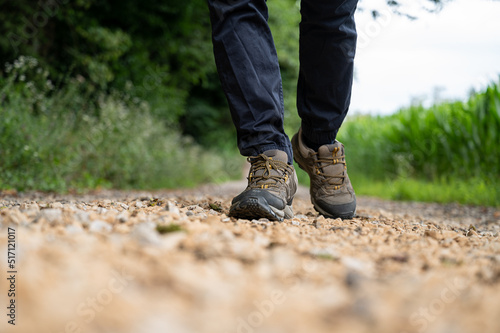 Male in hiking shoes walking on a trail