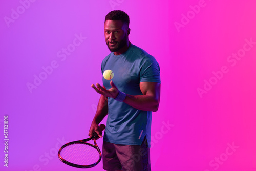 Image of african american male tennis player in violet and pink neon lighting © vectorfusionart