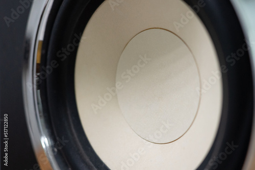 Cream music speaker with metal fastening close-up © Serhii