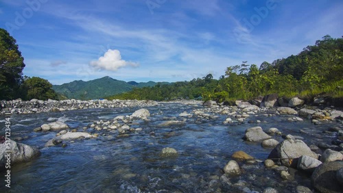 Timelapse of moving cloud and riverat Kota Belud, Sabah. Tilt Up effect photo